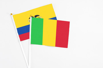 Mali and Ecuador stick flags on white background. High quality fabric, miniature national flag. Peaceful global concept.White floor for copy space.
