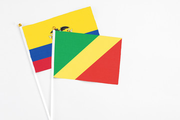 Republic Of The Congo and Ecuador stick flags on white background. High quality fabric, miniature national flag. Peaceful global concept.White floor for copy space.