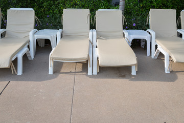 Sunbeds to relax by the pool for tourists.