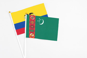 Turkmenistan and Ecuador stick flags on white background. High quality fabric, miniature national flag. Peaceful global concept.White floor for copy space.