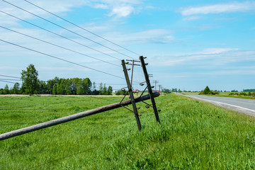 a power pole by the roadside had fallen from old age