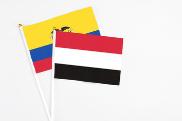 Yemen and Ecuador stick flags on white background. High quality fabric, miniature national flag. Peaceful global concept.White floor for copy space.