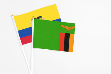 Zambia and Ecuador stick flags on white background. High quality fabric, miniature national flag. Peaceful global concept.White floor for copy space.