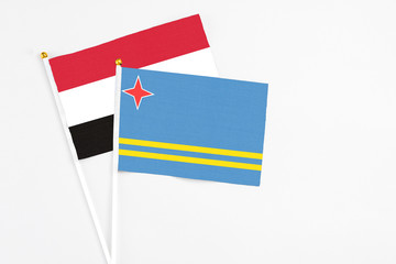 Aruba and Egypt stick flags on white background. High quality fabric, miniature national flag. Peaceful global concept.White floor for copy space.