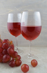 Two Glasses of Delicious Red Wine with Fresh Grapes