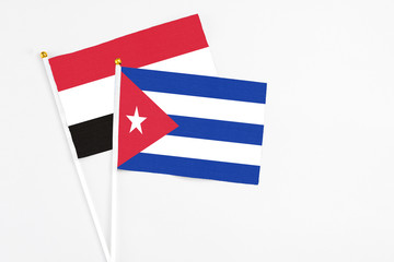 Cuba and Egypt stick flags on white background. High quality fabric, miniature national flag. Peaceful global concept.White floor for copy space.