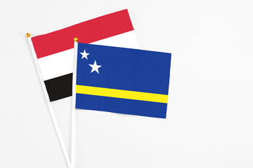 Curacao and Egypt stick flags on white background. High quality fabric, miniature national flag. Peaceful global concept.White floor for copy space.