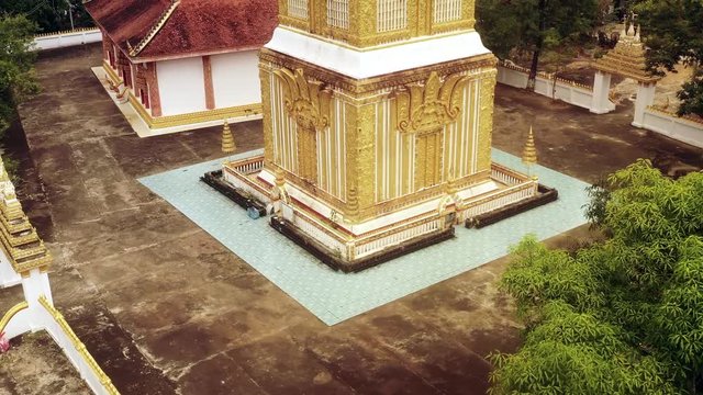 Aerial view of golden buddhist stupa at wat pha bat phonesan, Borikhamxay province, Laos