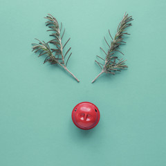 Minimal red nose reindeer made from rosemary and red decor bell, Christmas hipster festive...