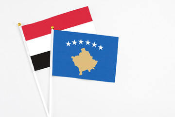 Kosovo and Egypt stick flags on white background. High quality fabric, miniature national flag. Peaceful global concept.White floor for copy space.
