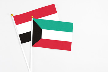 Kuwait and Egypt stick flags on white background. High quality fabric, miniature national flag. Peaceful global concept.White floor for copy space.