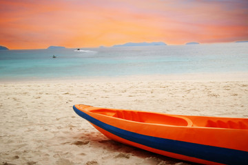 orange kayak boat on beach