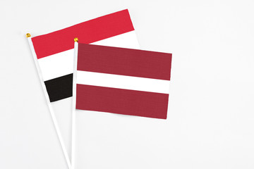 Latvia and Egypt stick flags on white background. High quality fabric, miniature national flag. Peaceful global concept.White floor for copy space.