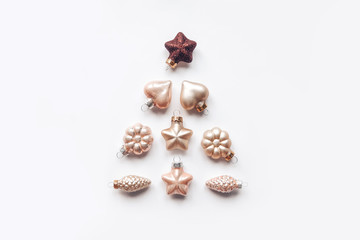 Creative composition of a Christmas tree from decorative ornaments. Flat lay, pastel. Minimalism.