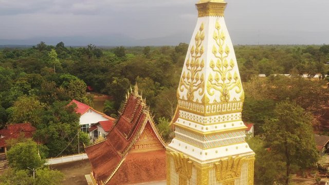 Aerial view of golden buddhist stupa at wat pha bat phonesan, Borikhamxay province, Laos
