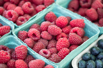 Fresh raspberry in green paper basket for sell