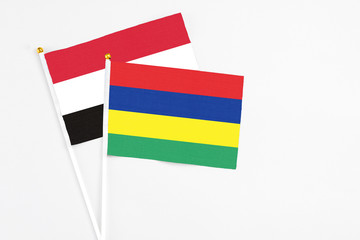 Mauritius and Egypt stick flags on white background. High quality fabric, miniature national flag. Peaceful global concept.White floor for copy space.