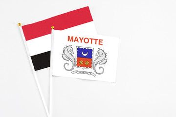 Mayotte and Egypt stick flags on white background. High quality fabric, miniature national flag. Peaceful global concept.White floor for copy space.