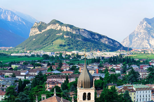 Landscape with Church Santa Maria Assunta on rock at Sarca Valley near Garda lake of Trentino in Italy. Scenery with Cathedral on mountain of Arco town in Trento near Riva del Garda