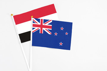 New Zealand and Egypt stick flags on white background. High quality fabric, miniature national flag. Peaceful global concept.White floor for copy space.