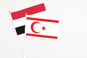 Northern Cyprus and Egypt stick flags on white background. High quality fabric, miniature national flag. Peaceful global concept.White floor for copy space.