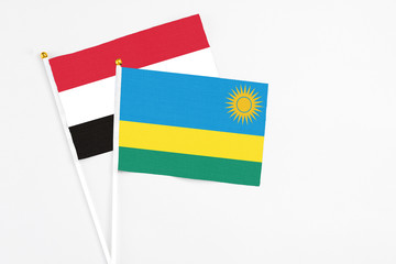 Rwanda and Egypt stick flags on white background. High quality fabric, miniature national flag. Peaceful global concept.White floor for copy space.