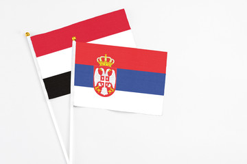 Serbia and Egypt stick flags on white background. High quality fabric, miniature national flag. Peaceful global concept.White floor for copy space.