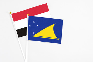 Tokelau and Egypt stick flags on white background. High quality fabric, miniature national flag. Peaceful global concept.White floor for copy space.