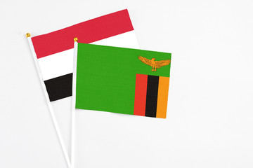 Zambia and Egypt stick flags on white background. High quality fabric, miniature national flag. Peaceful global concept.White floor for copy space.