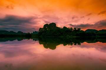 Natural background of a large reservoir in Krabi,Thailand(Nong Thale)atmosphere surrounded by mountains,trees of various sizes, blown through the wind,blurred cool during the day,a viewpoint of travel