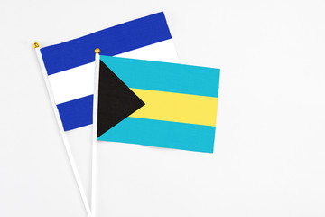 Bahamas and El Salvador stick flags on white background. High quality fabric, miniature national flag. Peaceful global concept.White floor for copy space.