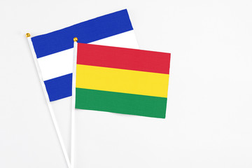 Bolivia and El Salvador stick flags on white background. High quality fabric, miniature national flag. Peaceful global concept.White floor for copy space.