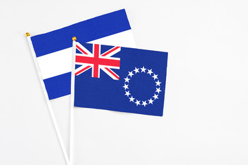 Cook Islands and El Salvador stick flags on white background. High quality fabric, miniature national flag. Peaceful global concept.White floor for copy space.