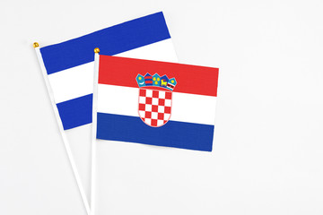 Croatia and El Salvador stick flags on white background. High quality fabric, miniature national...