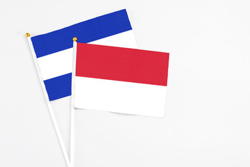 Indonesia and El Salvador stick flags on white background. High quality fabric, miniature national flag. Peaceful global concept.White floor for copy space.