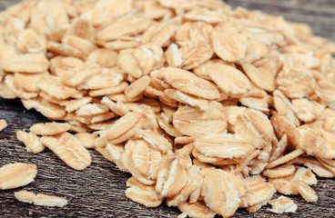 Oat flakes as source dietary fiber. Wooden background