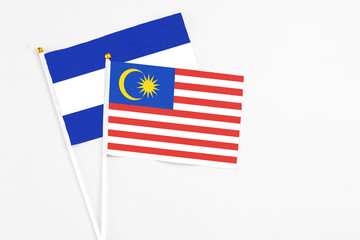 Malaysia and El Salvador stick flags on white background. High quality fabric, miniature national flag. Peaceful global concept.White floor for copy space.