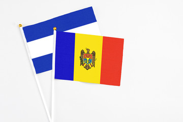 Moldova and El Salvador stick flags on white background. High quality fabric, miniature national flag. Peaceful global concept.White floor for copy space.