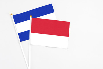 Monaco and El Salvador stick flags on white background. High quality fabric, miniature national flag. Peaceful global concept.White floor for copy space.
