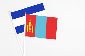 Mongolia and El Salvador stick flags on white background. High quality fabric, miniature national flag. Peaceful global concept.White floor for copy space.