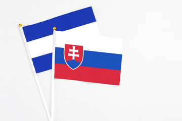 Slovakia and El Salvador stick flags on white background. High quality fabric, miniature national flag. Peaceful global concept.White floor for copy space. - obrazy, fototapety, plakaty