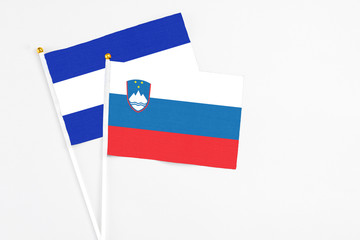 Slovenia and El Salvador stick flags on white background. High quality fabric, miniature national flag. Peaceful global concept.White floor for copy space.