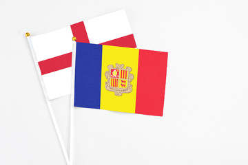 Andorra and England stick flags on white background. High quality fabric, miniature national flag. Peaceful global concept.White floor for copy space.