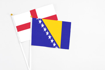Bosnia Herzegovina and England stick flags on white background. High quality fabric, miniature...