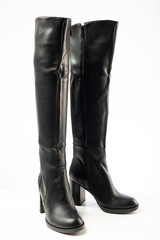 women's black leather high heeled boots isolated on white background