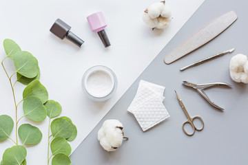 Stylish trendy manicure accessories with gel nail polishes, scissors, cuticle pusher, cotton and...