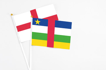 Central African Republic and England stick flags on white background. High quality fabric, miniature national flag. Peaceful global concept.White floor for copy space.