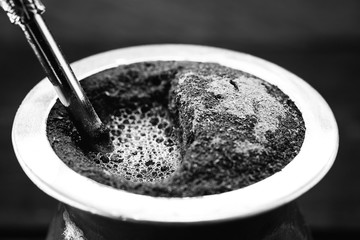 A typical Brazilian drink, o chimarrão, or mate, is a character, Black and white photography, drink in black and white. South American Tradition.