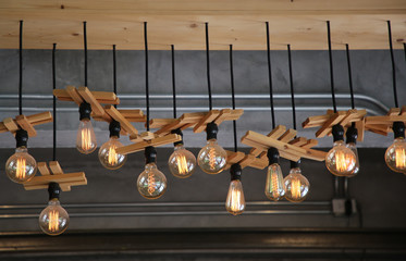 Modern wood lamp, bulb decorative on concrete wall background in home.