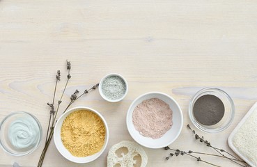 Cosmetic clay for facial mask, natural skin care, acne treatment, flat lay, wooden background, copy space.